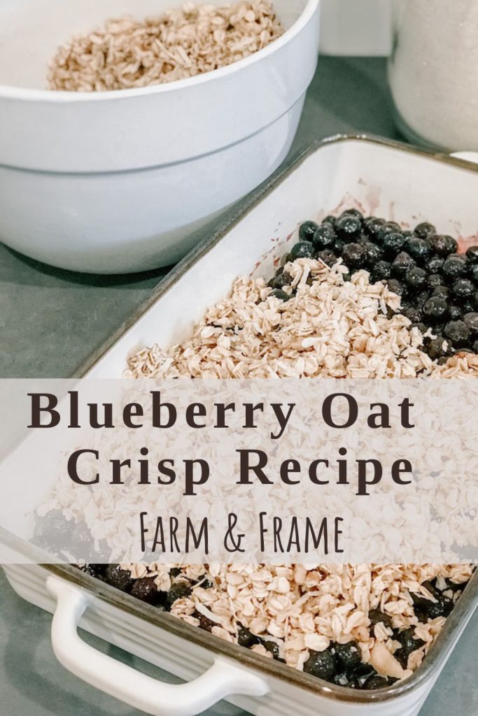 blueberries in a baking dish partially covered with oat crumble topping