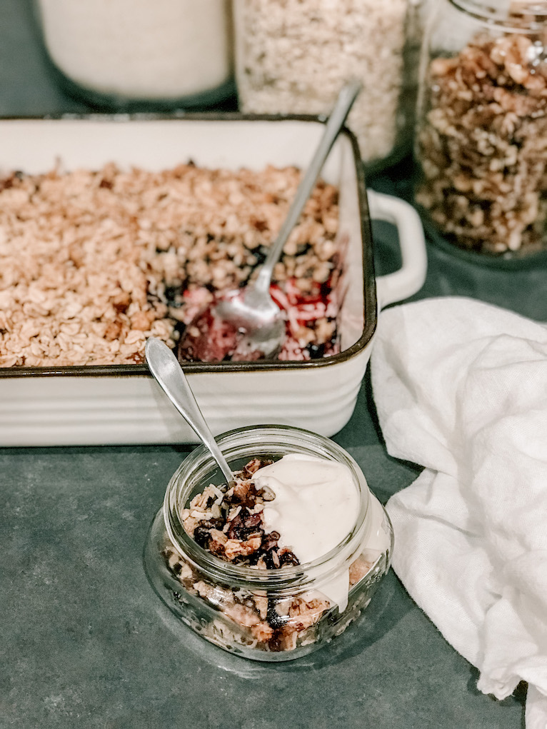 serving of blueberry oat crisp and yogurt with ingredient on countertop