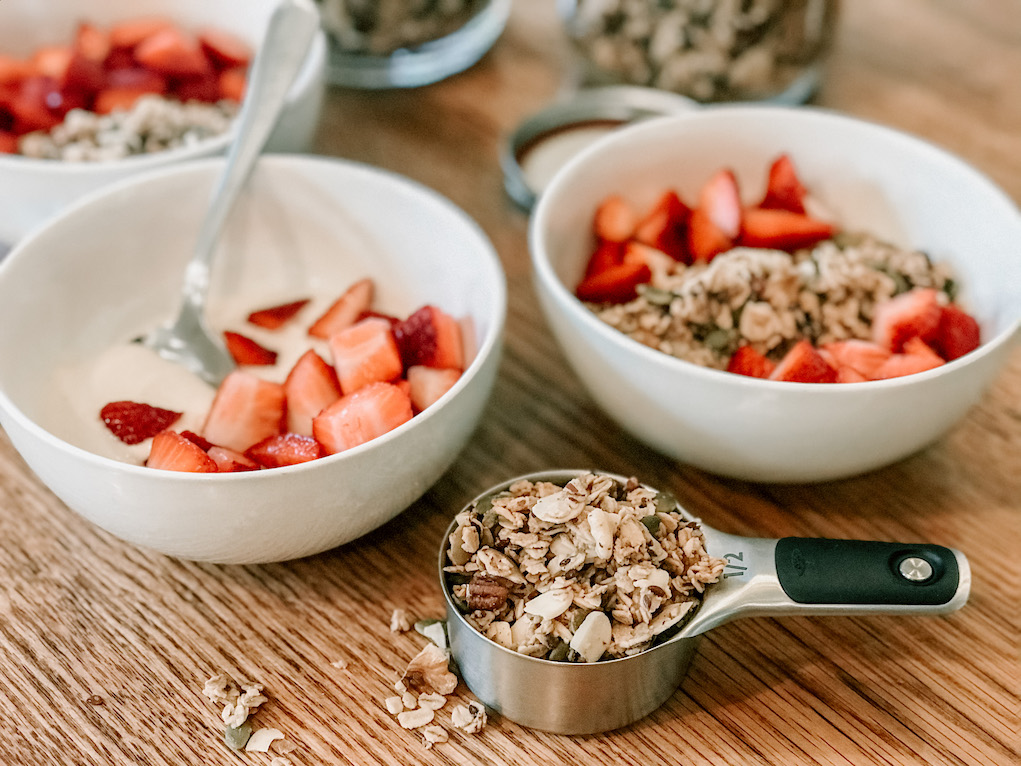 homemade granola in measuring cup on table